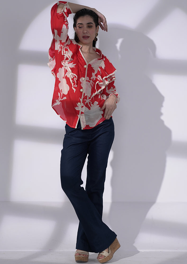 Red and white floral-printed chiffon ruffle shirt with lace and pearl buttons. IKI CHIC Private Ltd.