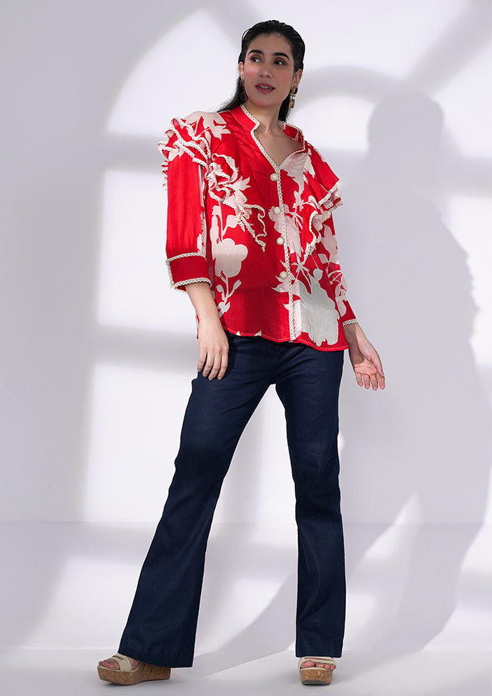 Red and white floral-printed chiffon ruffle shirt with lace and pearl buttons. IKI CHIC Private Ltd.